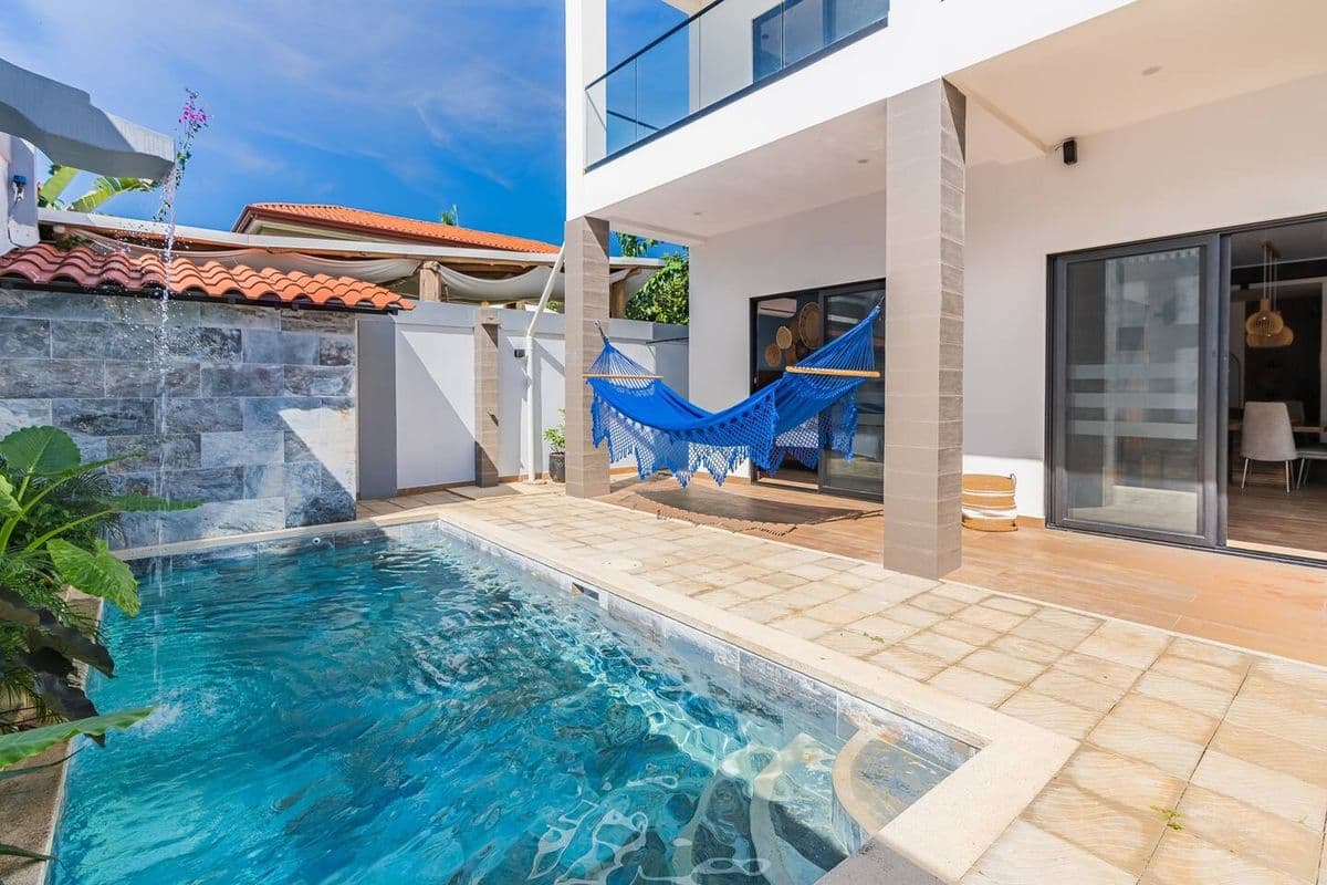 Private villa pool with hammock and patio